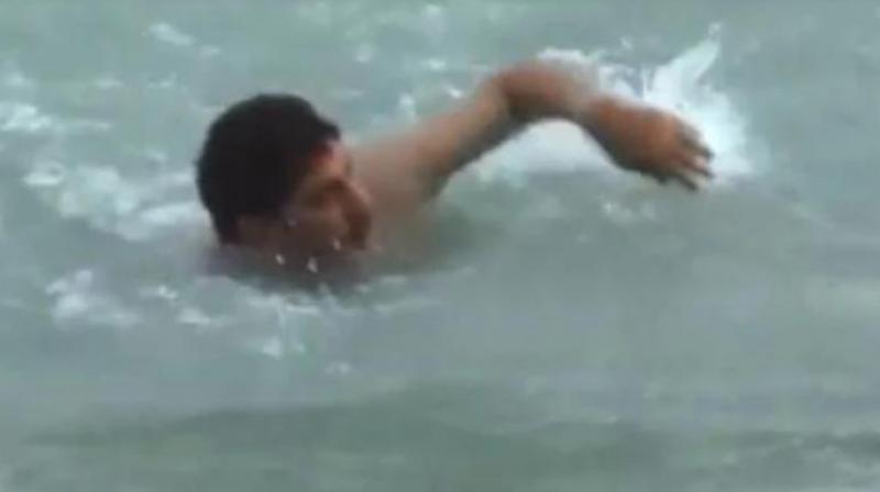 Aâ€‰video grab posted by Haryana BJP president Subhash Barala showing him swimming in a canal in Fatehabad district. (Screengrab | Twitter)