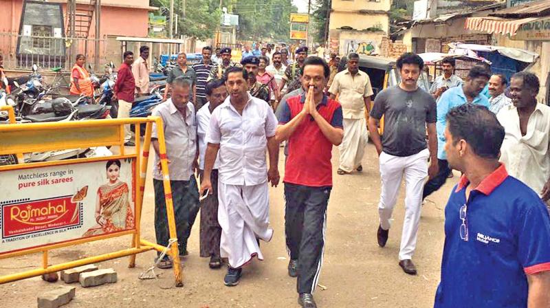 The leader of Opposition and DMK treasurer M. K. Stalin greets morning walkers in Chitirai streets around Meenakshi Amman temple at Madurai on Sunday morning. (Photo: DC)