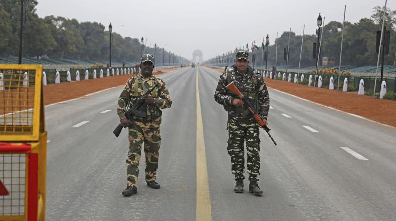 Paramilitary soldiers stand guard near a police barricade on Rajpath, the ceremonial boulevard, ahead of Republic Day in New Delhi. (Photo: AP)