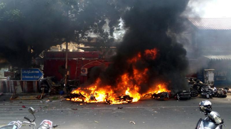 Jallikattu protesters attack Ice House police station near Chennais Marina Beach and set vehicles on fire. (Photo: DC)