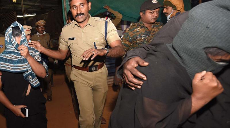 Reshma Nishanth and Shanila Rajesh being escorted by cops to the vehicle outside the police control room in Nilakkal on Saturday.
