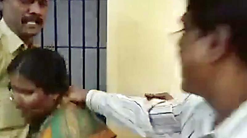 Screen grab of cops hitting a woman at Kumarswamy Layout police station