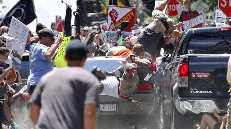 People fly into the air as a vehicle drives into a group of protesters demonstrating against a white nationalist rally in Charlottesville. (Photo: AP)