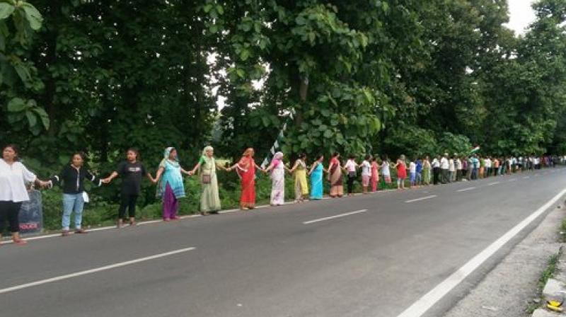 Gorkha Janmukti Morcha (GJM) activists form human chain during a protest in Sukna near Siliguri on Sunday. (Photo: PTI)