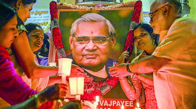 BJP members hold candles to pay tribute to former prime minister Atal Behari Vajpayee, in Bengaluru. (Photo: PTI)