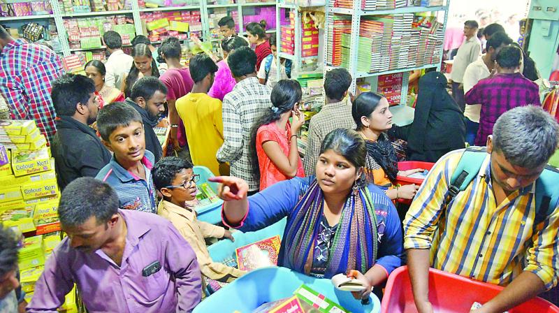 People buy crackers from a shop in Hyderabad ahead  of Diwali on Sunday.   (Photo:S. SURENDER REDDY)