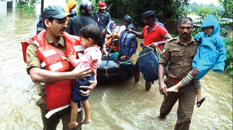 Fire and Rescue personnel evacuate residents of Muppathadam near Eloor in Kochi on Thursday. (Image: Arun Chandra Bose)