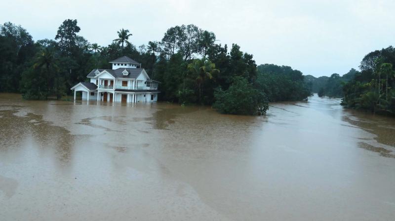A house stands immersed in flood waters at Moovattupuzha on Thursday.