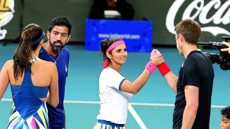 Indian Aces duo of Rohan Bopanna and Sania Mirza shake hands with Ana Ivanovic and Daniel Nestor of the UAE Royals after their International Premier Tennis League match at Gachibowli Stadium in Hyderabad on Saturday.