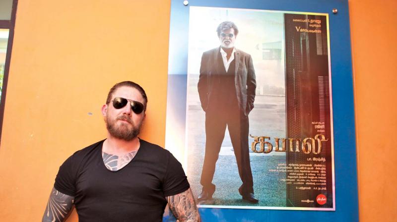 Greg poses with a Kabali poster in Chennai
