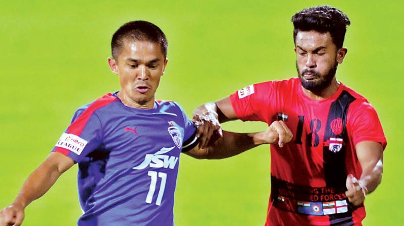BFC skipper Sunil Chhetri vies for the ball with Souvik Das of Minerva Punjab FC on Saturday. (Photo: R. SAMUEL)