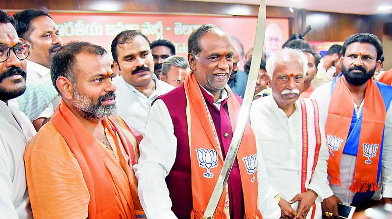 BJP leaders welcome Swami Paripoornanada, who joined the party recently, on his return from Delhi to Hyderabad on Wednesday. (Gandhi)