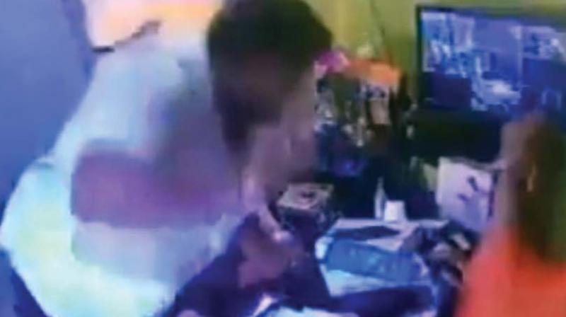 A CCTV grab of Ramakrishnappa assaulting the  headmistress in her office.