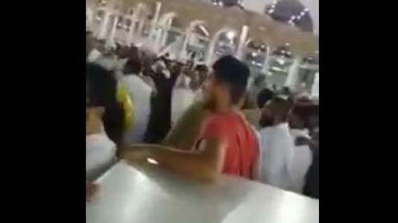 A video clip circulating on social media showed a man being hustled away from the Kaaba by pilgrims and security guards. (Photo: YouTube Screengrab)
