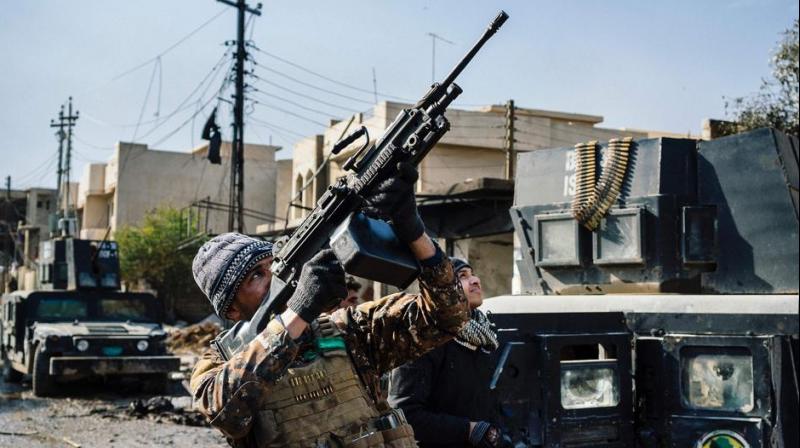 An Iraqi special forces Counter Terrorism Service (CTS) member shoots at a drone flown by Islamic State group jihadists (IS) in Mosuls al-Rifaq neighbourhood on January 8. (Photo: AFP)