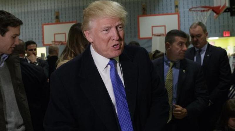 Republican presidential candidate Donald Trump talks with reporters before casting his ballot. (Photo: AP)
