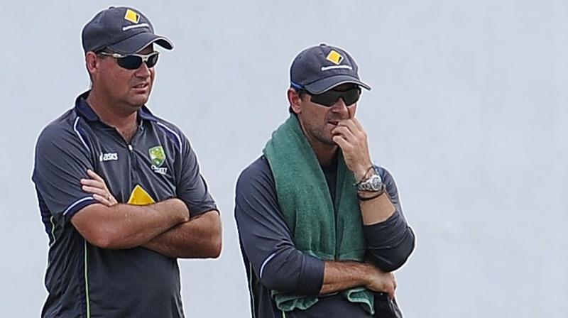Justin Langer (right) believes than a victory in India will be an indelible redemption for the emotionally scarred national team. (Photo: AFP)