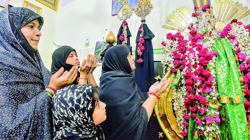Women offer prayers at the Bibi-ka-Alawa in Dabeerpura in the Old City on the eight day of Muharram. The main procession will be taken out on Sunday. 	(Photo: P.Surendra)