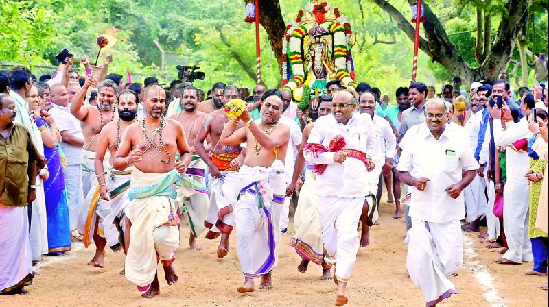 Priests throw silver spears at wild beast tied to the bushes on behalf of Lord Malayappa as part of the hunting safari held at Paruveta Mandapam in Tirumala on Friday.  (DC)