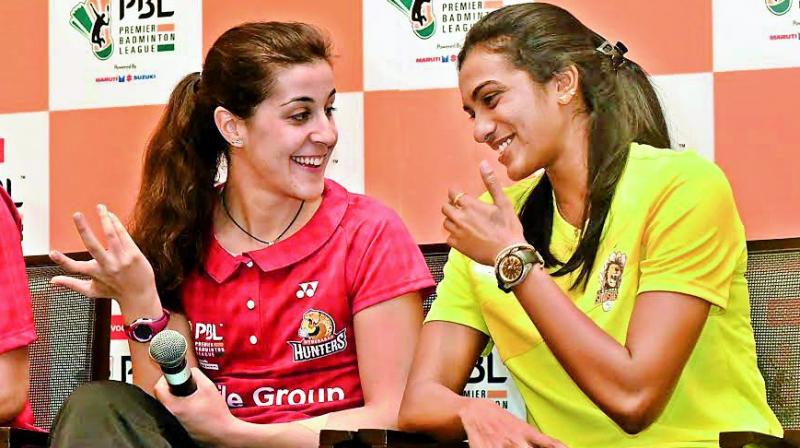 Spains Carolina Marin (left) and P.V. Sindhu share a light moment at the PBL pre-event press conference in Hyderabad on Friday.(Photo: R. PAVAN)