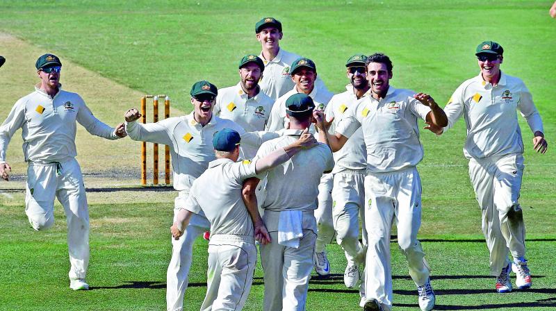 Australian players celebrate defeating Pakistan by an innings and 18 runs on the fifth day of their second Test in Melbourne on Friday.(Photo: AP)