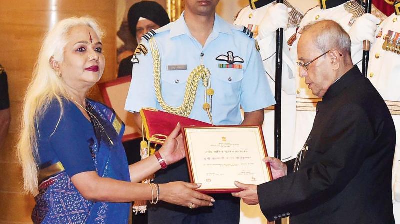 President Pranab Mukherjee  honours Kalyani Pramod Balakrishna of Tamil Nadu with Nari Shakti Puraskar at Rashtrapati Bhawan in New Delhi on Wednesday. (Photo: AP)