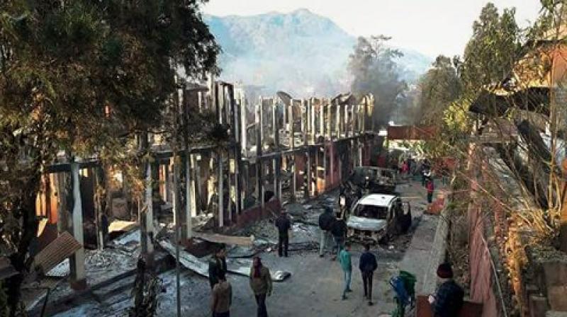 Naga tribals set ablaze the Kohima Municipal Council office and the office of the district collector during their violent protest, in Kohima. (Photo: PTI)