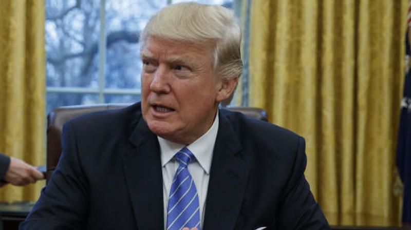 President Donald Trump sits at his desk in the Oval Office of the White House in Washington. (Photo: AP)