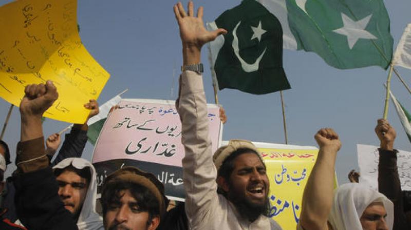 Supporters of Hafiz Saeed, head of the Pakistani religious charity, Jamaat-ud-Dawa, shout slogans to condemn his arrest, during a rally in Peshawar, Pakistan. (Photo: AP)