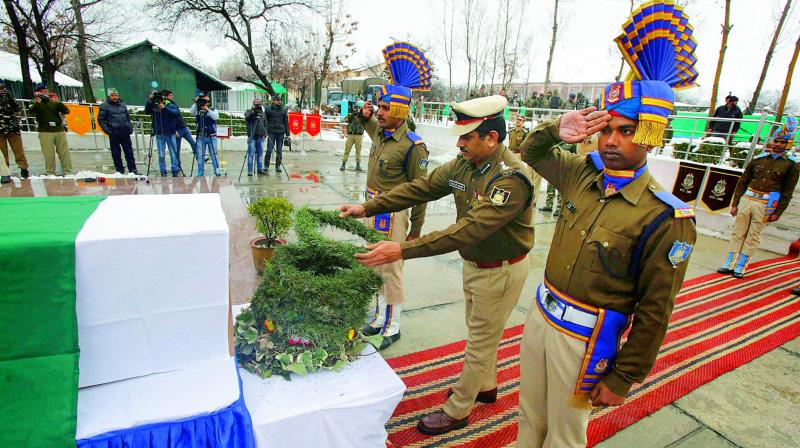 An officer pays tribute to CRPF jawan Mohammad Mujahid Khan, in Srinagar on Tuesday. (Photo: PTI)