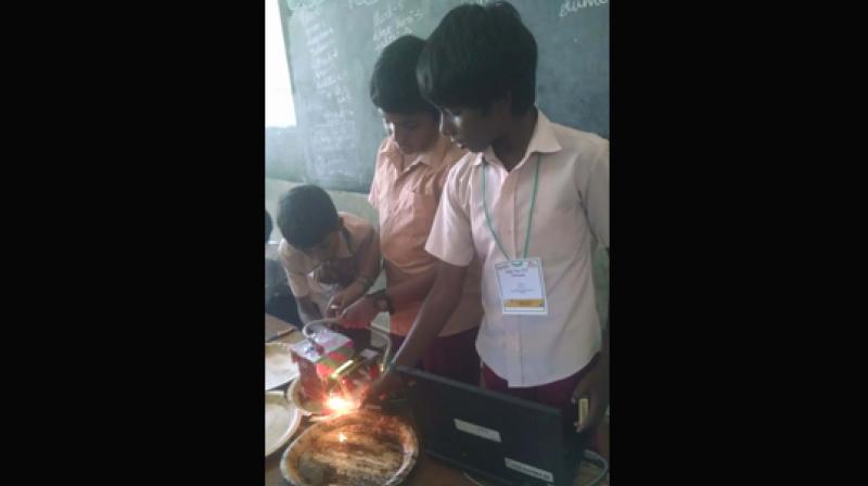 Students displaying their exhibits during the event.