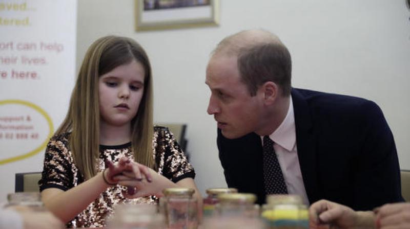 Britains Prince William speaks with Aoife, 9, during his visit to a Child Bereavement UK Centre in Stratford in east London. (Photo: AP)