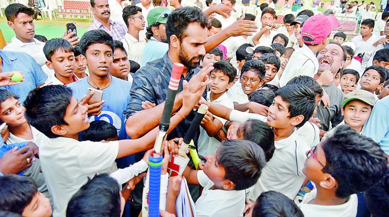 Test cricketer G. H. Vihari is mobbed by young cricketers for autographs and selfies during his felicitation event at the St Johns Cricket Academy in Secunderabad on Saturday. (Photo: S. Surender Reddy)