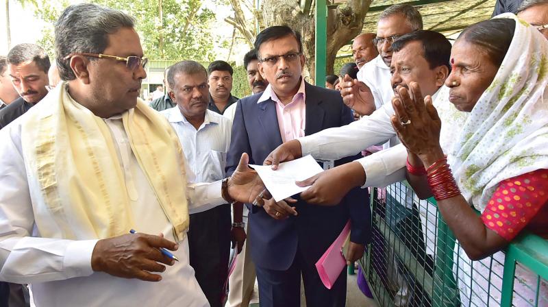 Chief Minister Siddaramaiah listens to public grievances during the Janata Darshan at Krishna, his home office in Bengaluru on Friday.