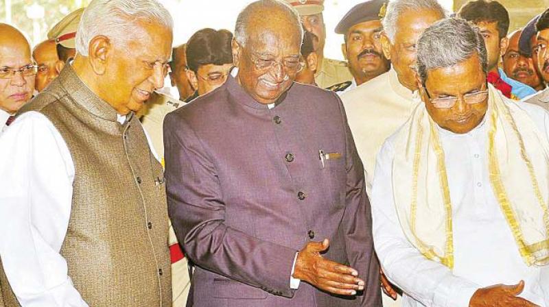 Council chairman D.H. Shankarmurthy who is tipped to become Governor, with Karnataka governor Vajubhai Vala and Chief Minister Siddaramaiah in a file photo