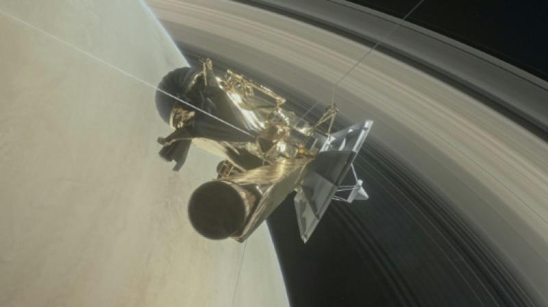 This NASA handout image depicts the Cassini unmanned spacecraft above Saturns rings