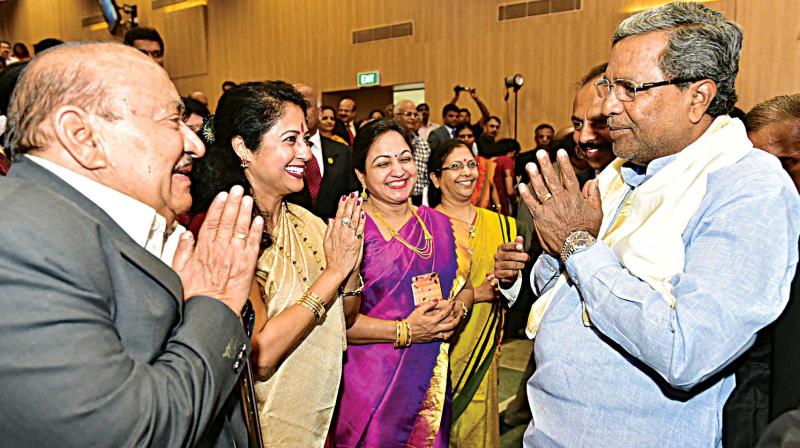 Chief Minister Siddaramaiah greets participants during the inauguration of the centenary building of FKCCI in Bengaluru on Wednesday