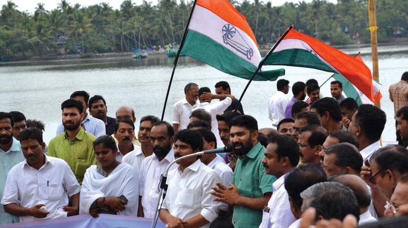 V.T. Balram, MLA, speaks on the banks of Karattu puzha near Vadakara, against an alleged encroachment into the river bank on Friday. DCC president T. Siddique is also seen.  (Photo:  DC)