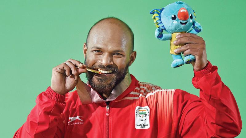 Gold medallist Indian weightlifter Sathish Kumar Sivalingam during the medal ceremony of the mens 77 kg Weightlifting category during the Commonwealth Games 2018 in Gold Coast, on Saturday. (Photo: AP)