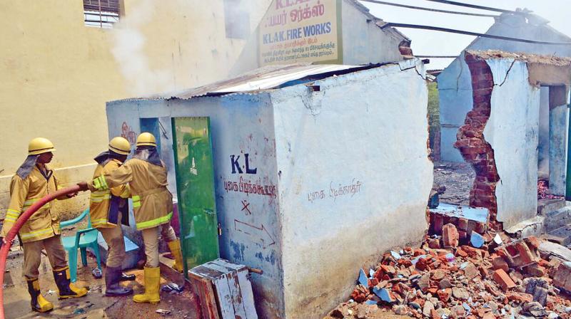 Firemen dousing the fire that broke out in the storage room of a fireworks unit near Vellore on Saturday.(Photo: . Senthil Nathan)
