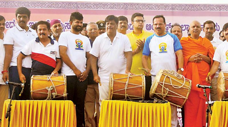 Union minister D.V. Sadananda Gowda and PWD minister Dr H.C. Mahadevappa at a yoga day programme in Mysuru on Wednesday.