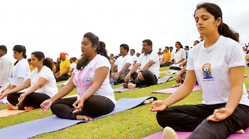 Arpitha Simha, wife of Mysuru Lok Sabha MP Pratap Simha, Arpitha Raj Randeep, wife of Mysuru DC D Randeep, and Dr Deepthi, wife of Mysuru city police commissioner Dr Subramanyeswar Rao  during the  yoga session in Mysuru on Wednesday.  (Photo: DC)