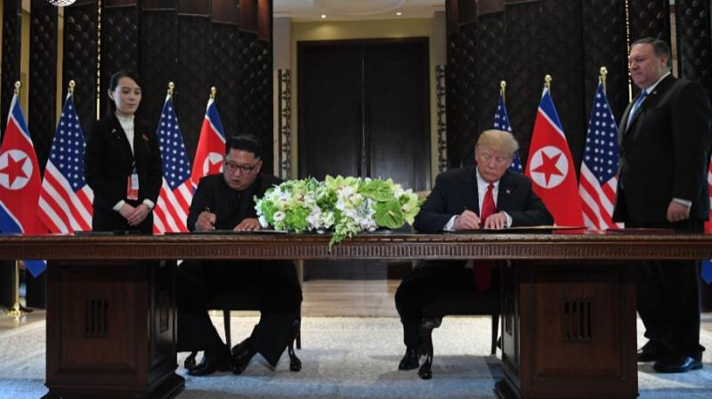 North Korea leader Kim Jong Un and US President Donald Trump sign a document at the Capella resort on Sentosa Island on Tuesday in Singapore. (Photo: AFP)