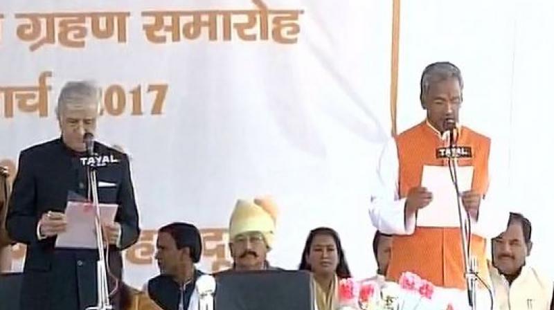 BJP legislature party leader Trivendra Singh Rawat on Saturday took oath as Uttarakhand Chief Minister. (Photo: ANI/Twitter)