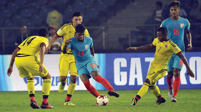 Indias Rahim Ali tries to make his way past Colombia players in the Under-17 World Cup Group A match at the Jawaharlal Nehru Stadium in New Delhi on Monday. Colombia won 2-1. (Photo: Pritam Bandyopadhyay)