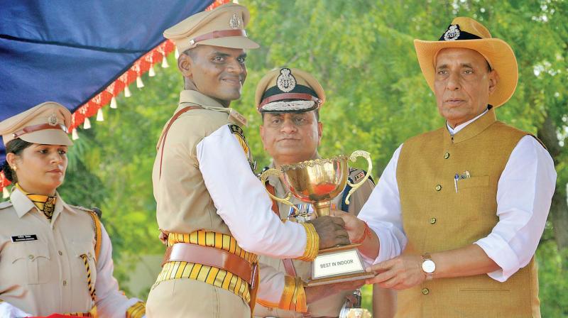 Home minister Rajnath Singh presents a cup to a successful CISF cadet in Arakkonam on Monday. (Photo: K. Senthilnathan)