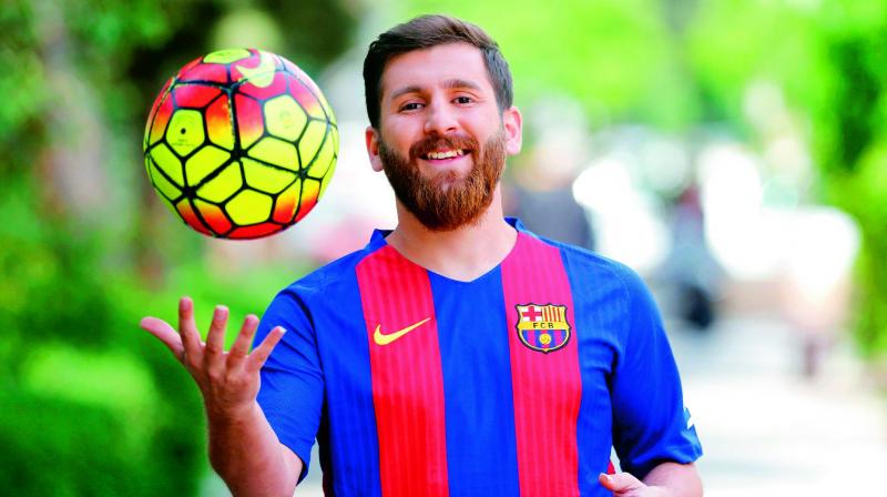 Reza Parastesh, a doppelganger of Lionel Messi, poses for a picture in Tehran on Monday. (Photo: AFP)