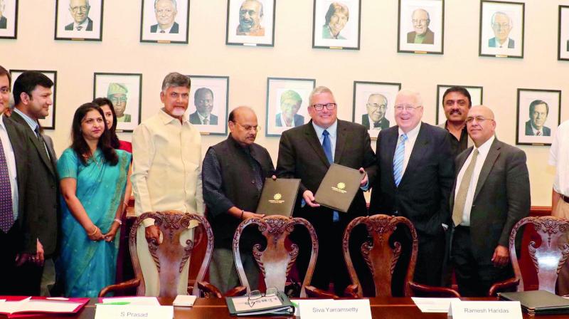 Minister Yanamala Ramakrishnudu exchanges an MoU with Iowa department of agriculture for research in the presence of Chief Minister N. Chandrababu Naidu and others in USA on Monday.