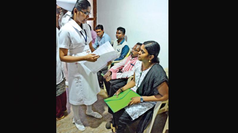 A nurse checks  the medical  certificate of a differently abled student  during  counselling.