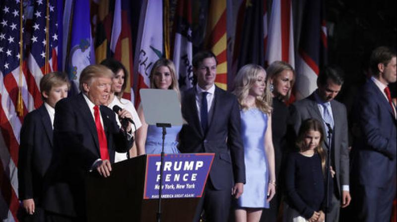 President-elect Donald Trump gives his acceptance speech as he is surrounded by his family during his election night rally, Wednesday, in New York. Photo: AP)